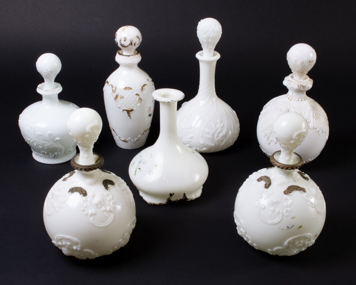 Lot of 7 Vintage Milk Glass Decanter Bottles with Stoppers Gold Painted Embossed