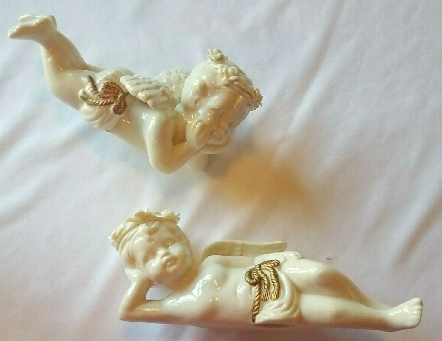 Berkeley Designs Set of Two White Ceramic Cherubs Lounging with Golden Ribbons
