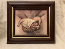 Lithograph On Canvas Of Black Man Holding Baby in His Hands picture