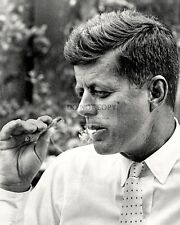 PRESIDENT JOHN F. KENNEDY SMOKES A CIGARILLO CIGAR IN 1963 - 8X10 PHOTO (OP-531) picture