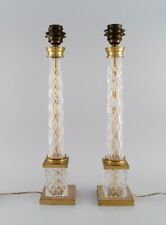 A pair of tall and sleek table lamps in clear crystal glass and brass. picture