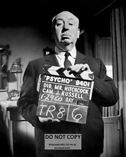 ALFRED HITCHCOCK HOLDING CLAPPERBOARD ON THE SET OF 