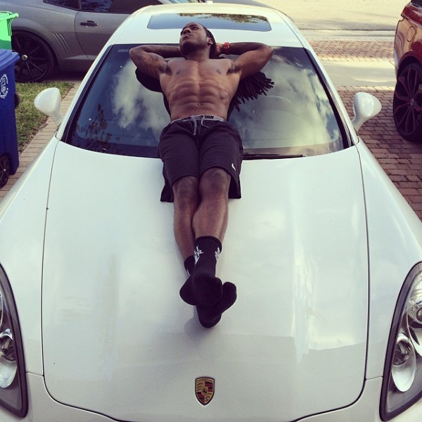 acehood laying on his Porsche Panamera Hood