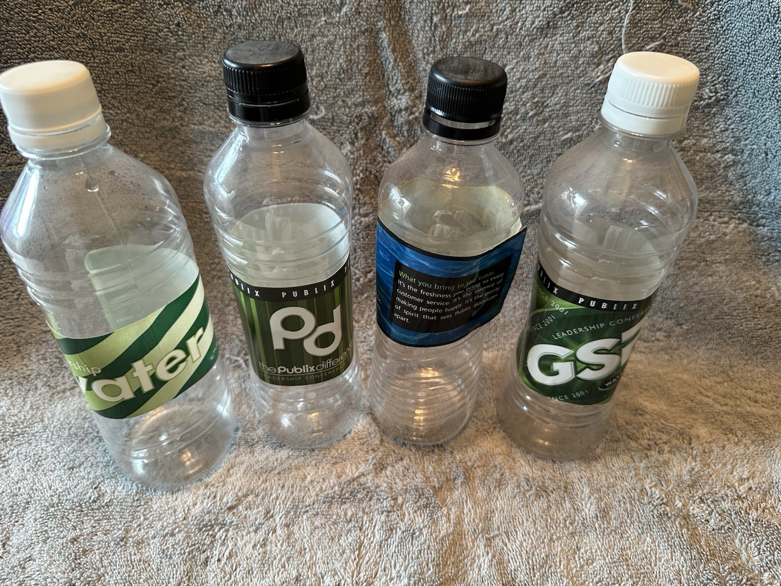 Four Empty Themed Water Bottles from Past Publix ROC