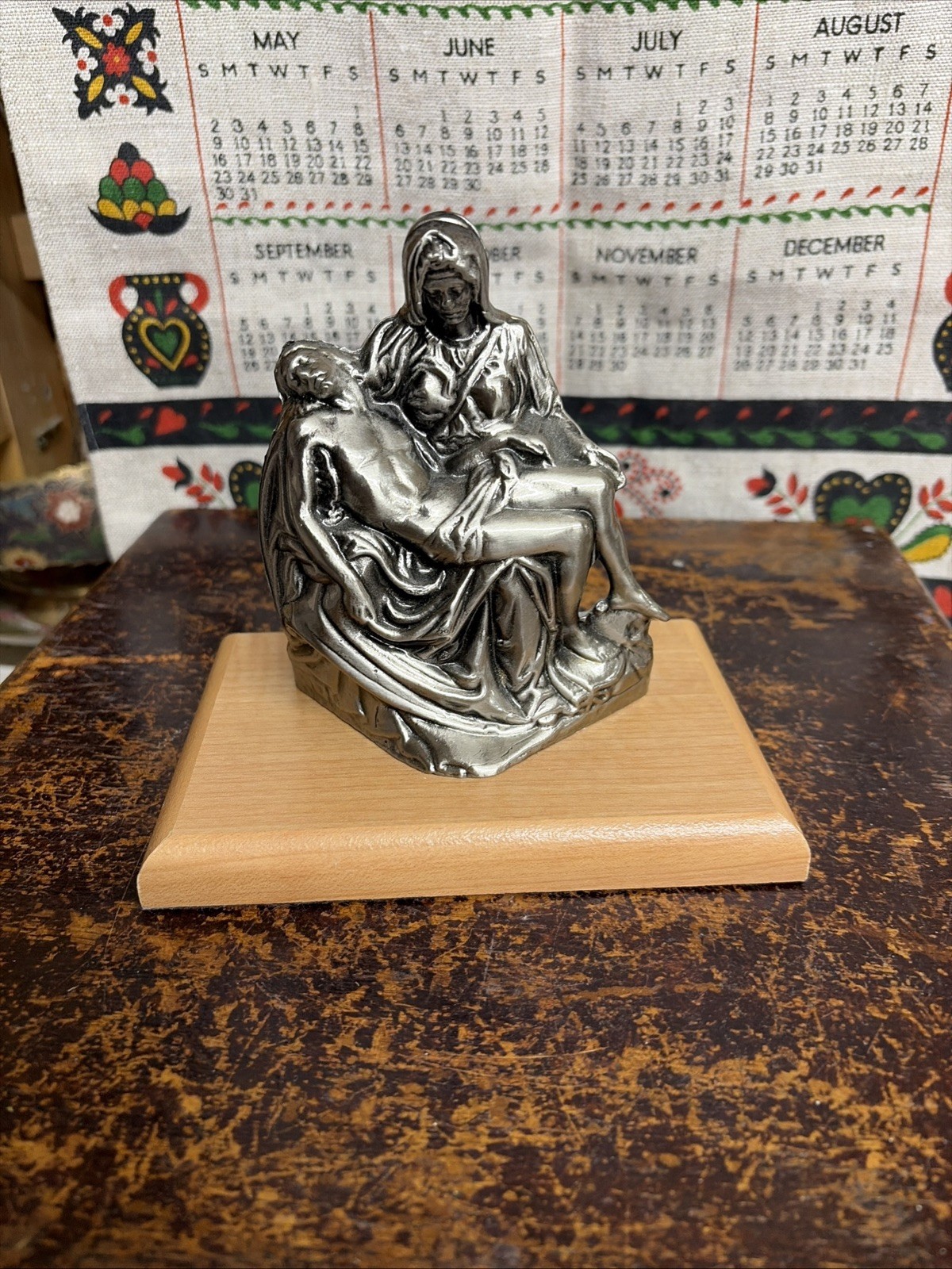 The Pieta by Michelangelo Jesus Christ and Mother Mary statue on wood base The Pieta by Michelangelo Jesus Christ and Mother Mary statue on wood base