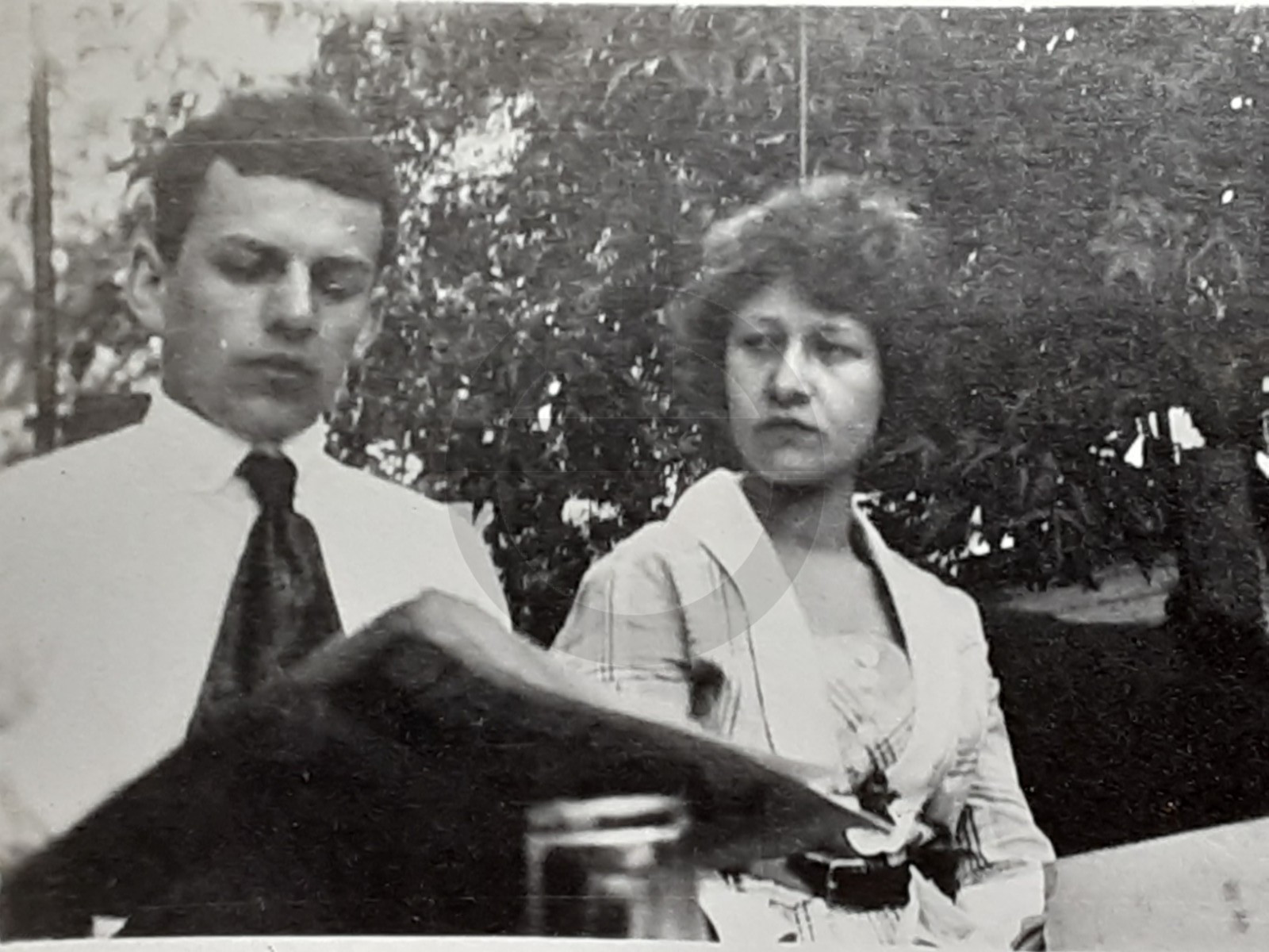 Woman Looks Pissed That Serious Young Man is Ignoring Her: 1920's Snapshot Photo Woman Looks Pissed That Serious Young Man is Ignoring Her: 1920's Snapshot Photo