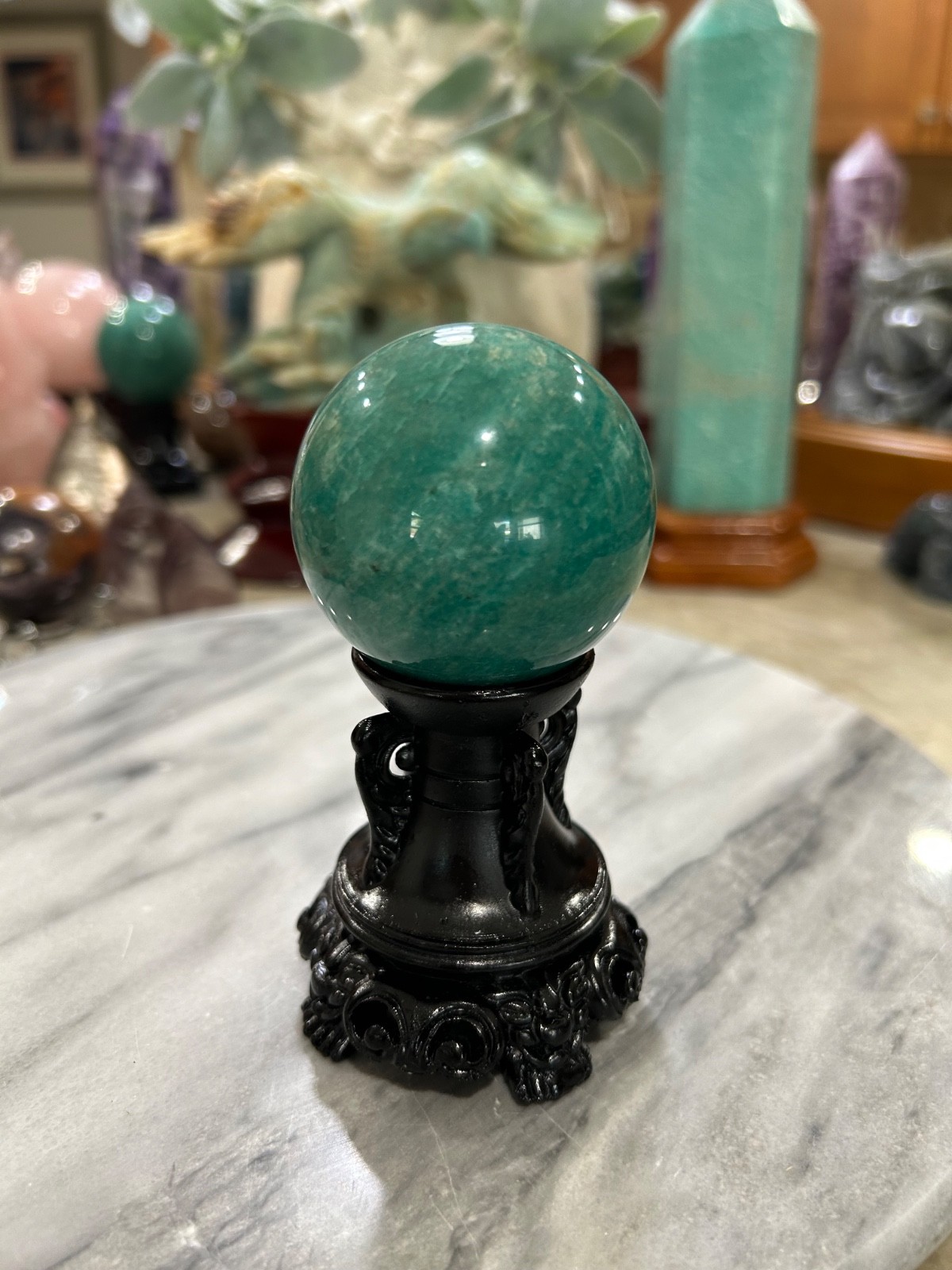 Amazonite high grade sphere with black resin stand 2.11” Amazonite high grade sphere with black resin stand 2.11”
