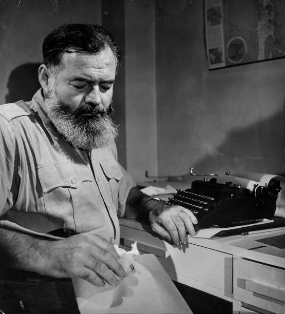 Author Ernest Hemingway sitting at a typewriter 1940s Old Photo