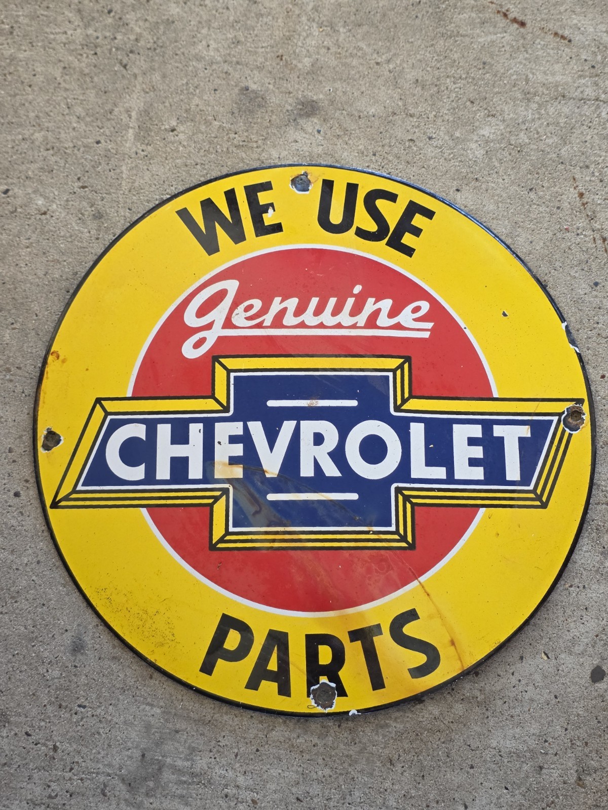 VINTAGE WE USE GENUINE CHEVROLET PARTS PORCELAIN SIGN 12". VINTAGE WE USE GENUINE CHEVROLET PARTS PORCELAIN SIGN 12".