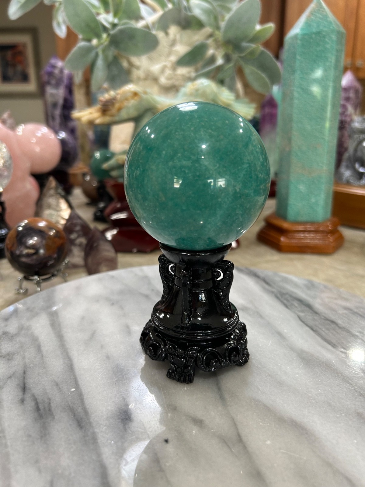 Amazonite high grade sphere with black resin stand 2.80” Amazonite high grade sphere with black resin stand 2.80”