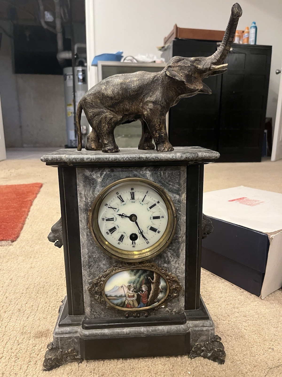 Antique French-style marble and bronze elephant mantel clock. Antique French-style marble and bronze elephant mantel clock.