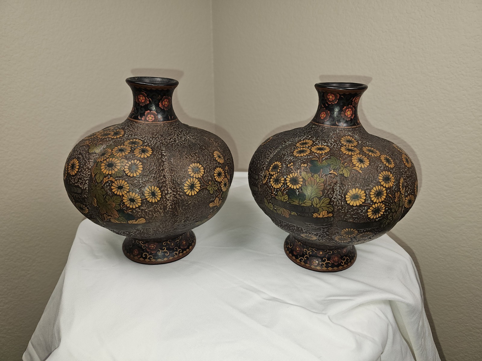 Matching pair of vintage Asian ceramic vases featuring rounded bodies Matching pair of vintage Asian ceramic vases featuring rounded bodies