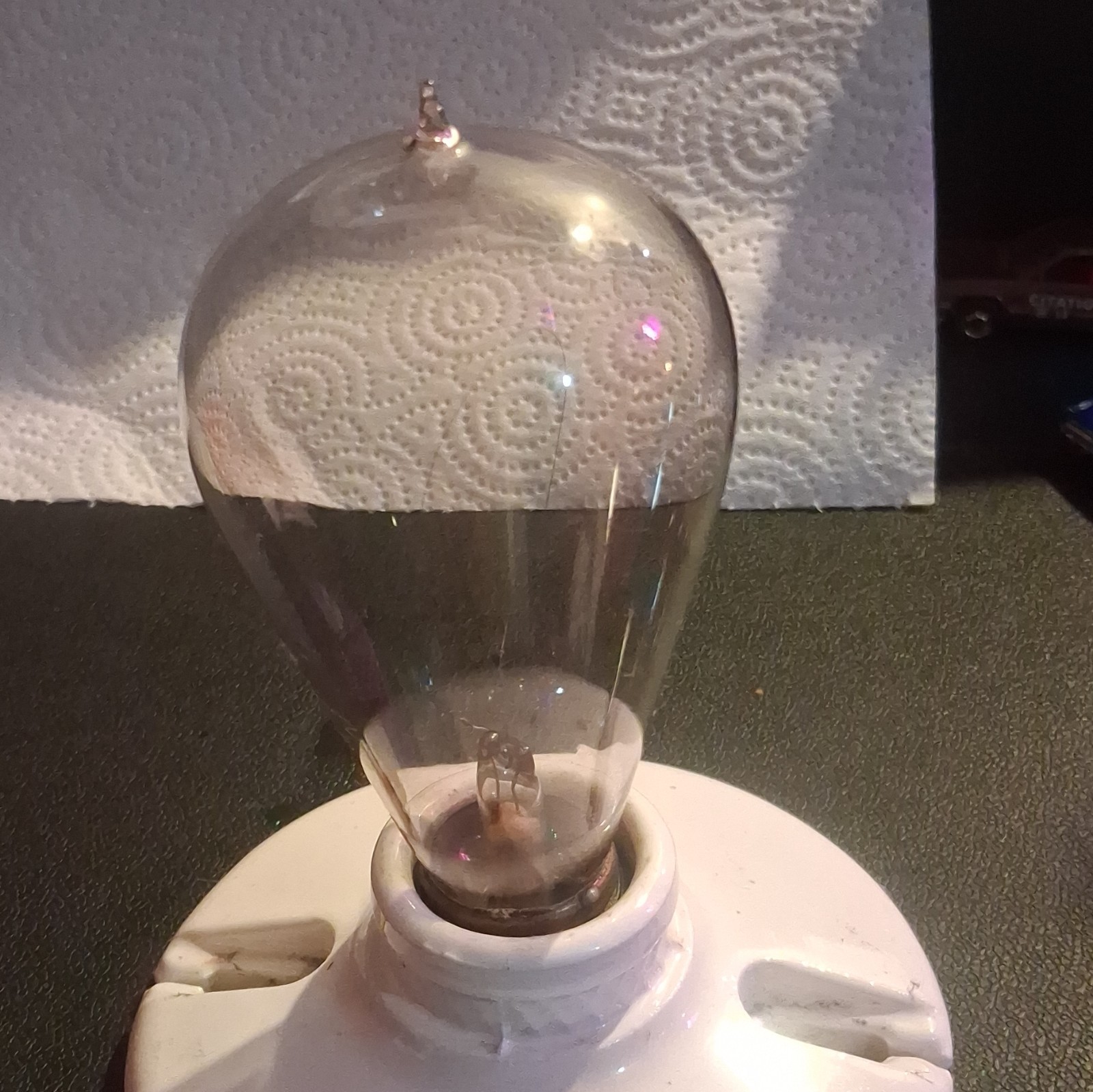 vintage 1890's hand blown working light bulb. on a vintage porcelain socket. vintage 1890's hand blown working light bulb. on a vintage porcelain socket.