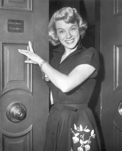 American actor singer Rosemary Clooney points to her nameplate exte- Old Photo American actor singer Rosemary Clooney points to her nameplate exte- Old Photo