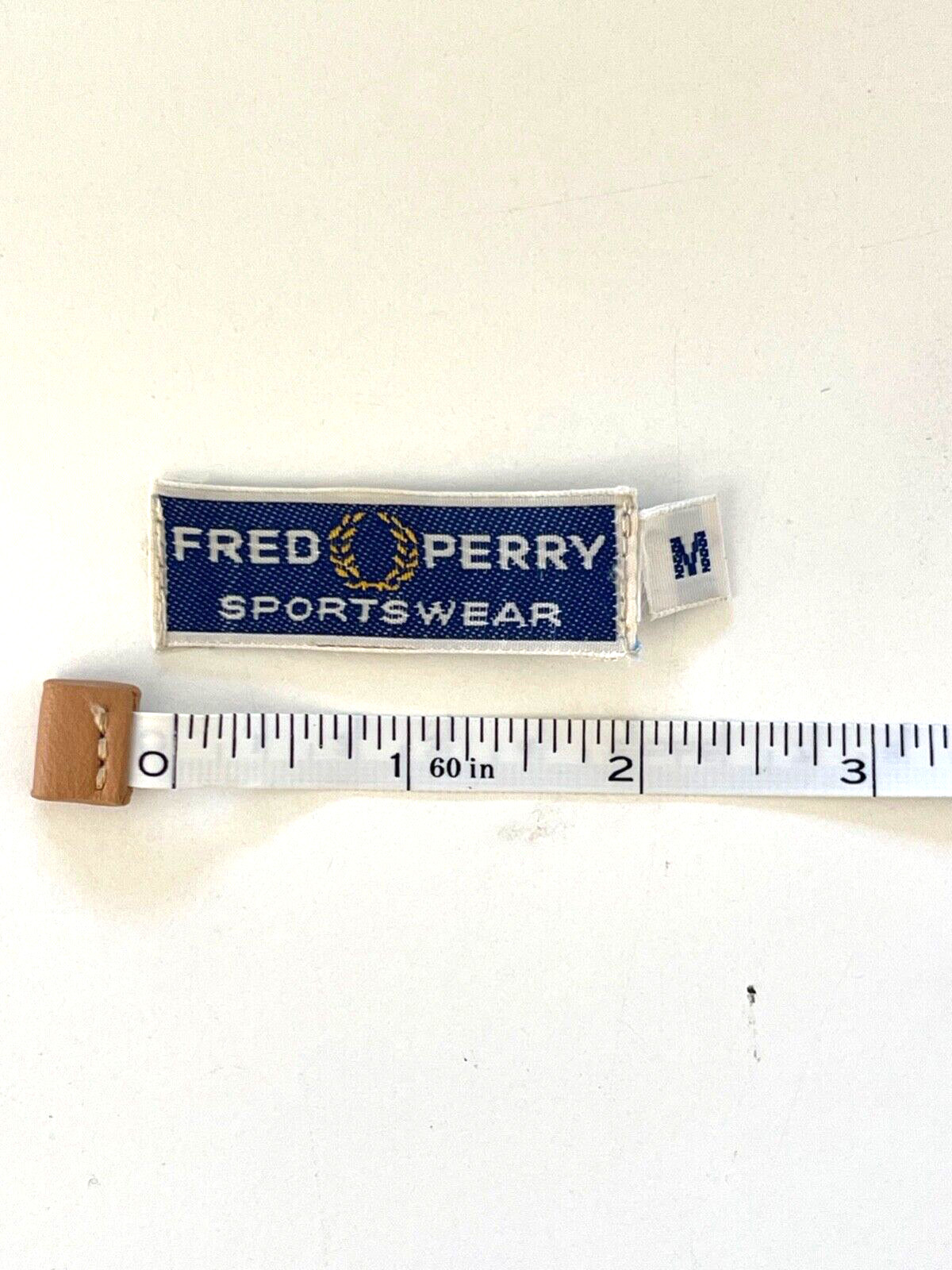 Vintage label Fred Perry Sportswear with size salvaged from garment Vintage label Fred Perry Sportswear with size salvaged from garment