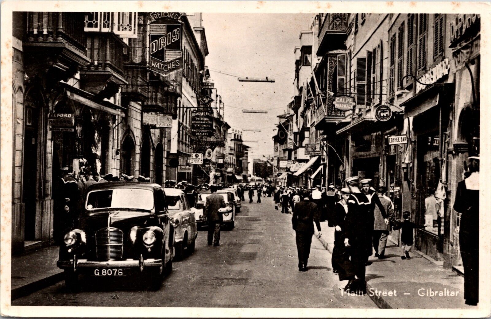 Vnt  RPPC Postcard- Gibraltar Main St Shops And Sailors- Tourists- Classic Cars