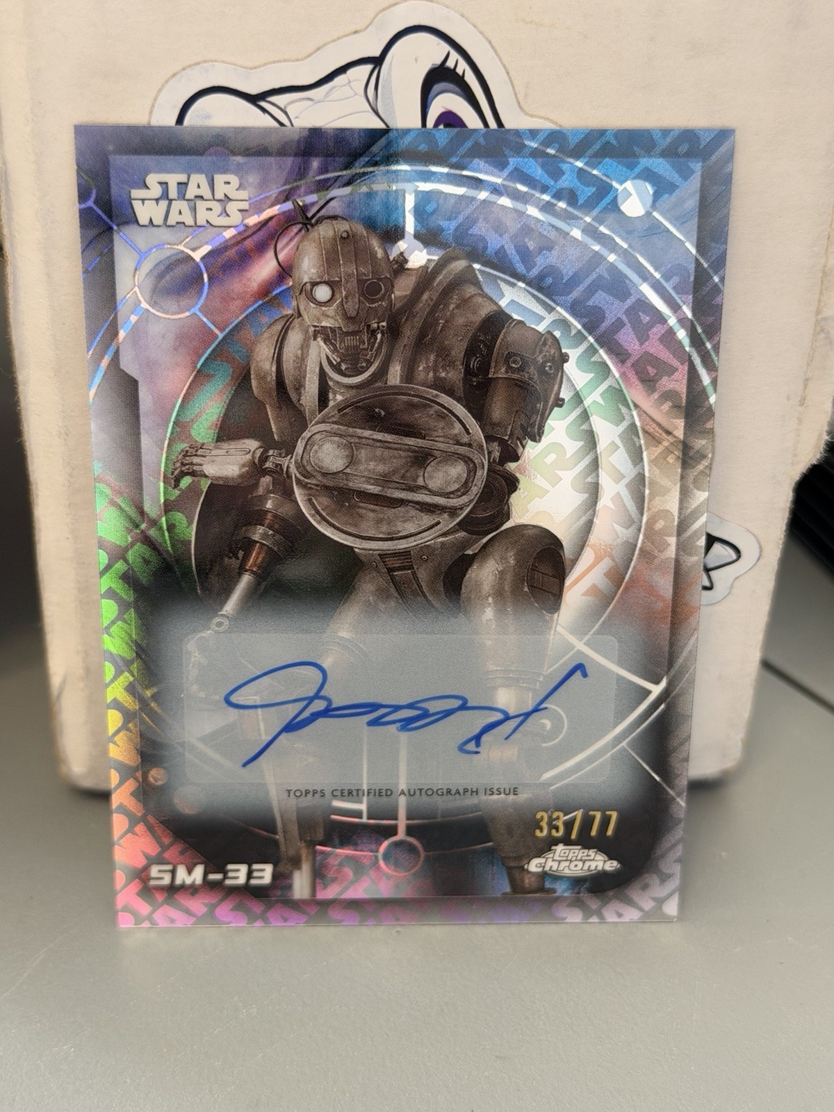 2026 TOPPS CHROME STAR WARS SM-33 AUTO 33/77 STAR WARS LOGO -COLLECTORS PIECE 2026 TOPPS CHROME STAR WARS SM-33 AUTO 33/77 STAR WARS LOGO -COLLECTORS PIECE