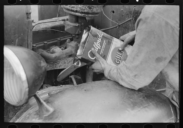 Photo:Harlingen Texas 1939 Migrant Worker Pouring Oil into Car Motor FSA Photo:Harlingen Texas 1939 Migrant Worker Pouring Oil into Car Motor FSA