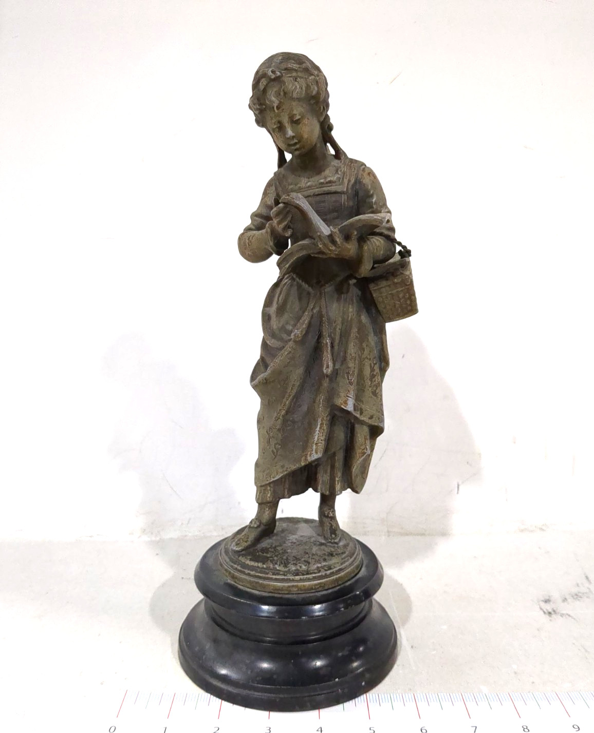 ANTIQUE VICTORIAN SPELTER FIGURE OF A STUDENT GIRL ON CAST IRON BASE. 13"