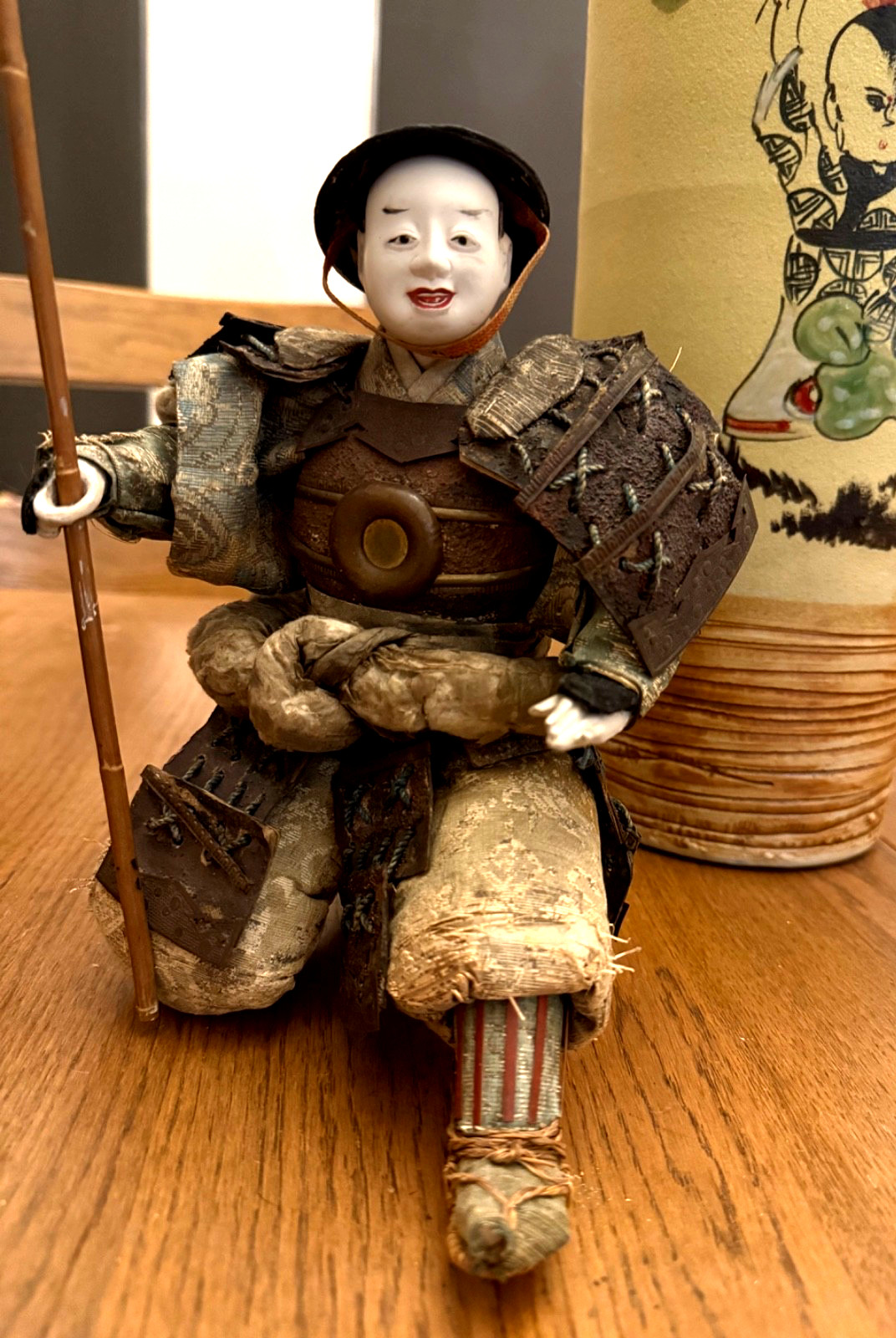 ANTIQUE JAPANESE SAMURAI DOLL HOLDING FLAG.