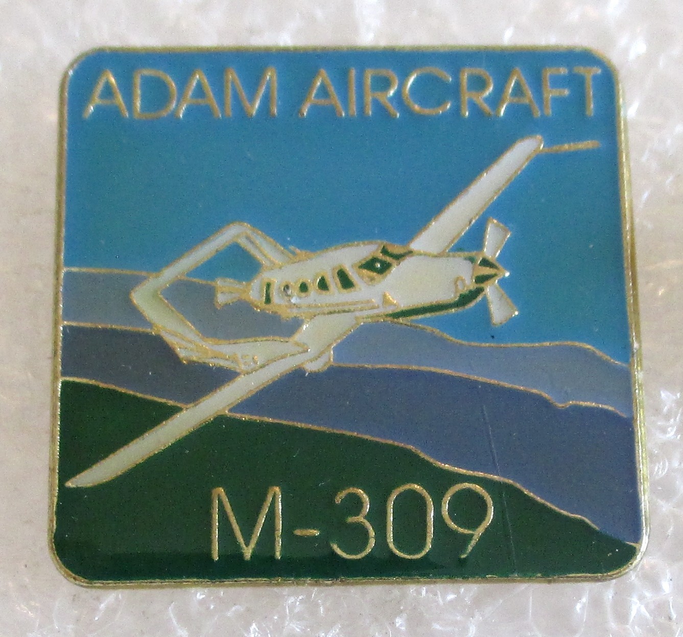 Adam Aircraft Industries M-309 Airplane Souvenir Collector Pin Adam Aircraft Industries M-309 Airplane Souvenir Collector Pin