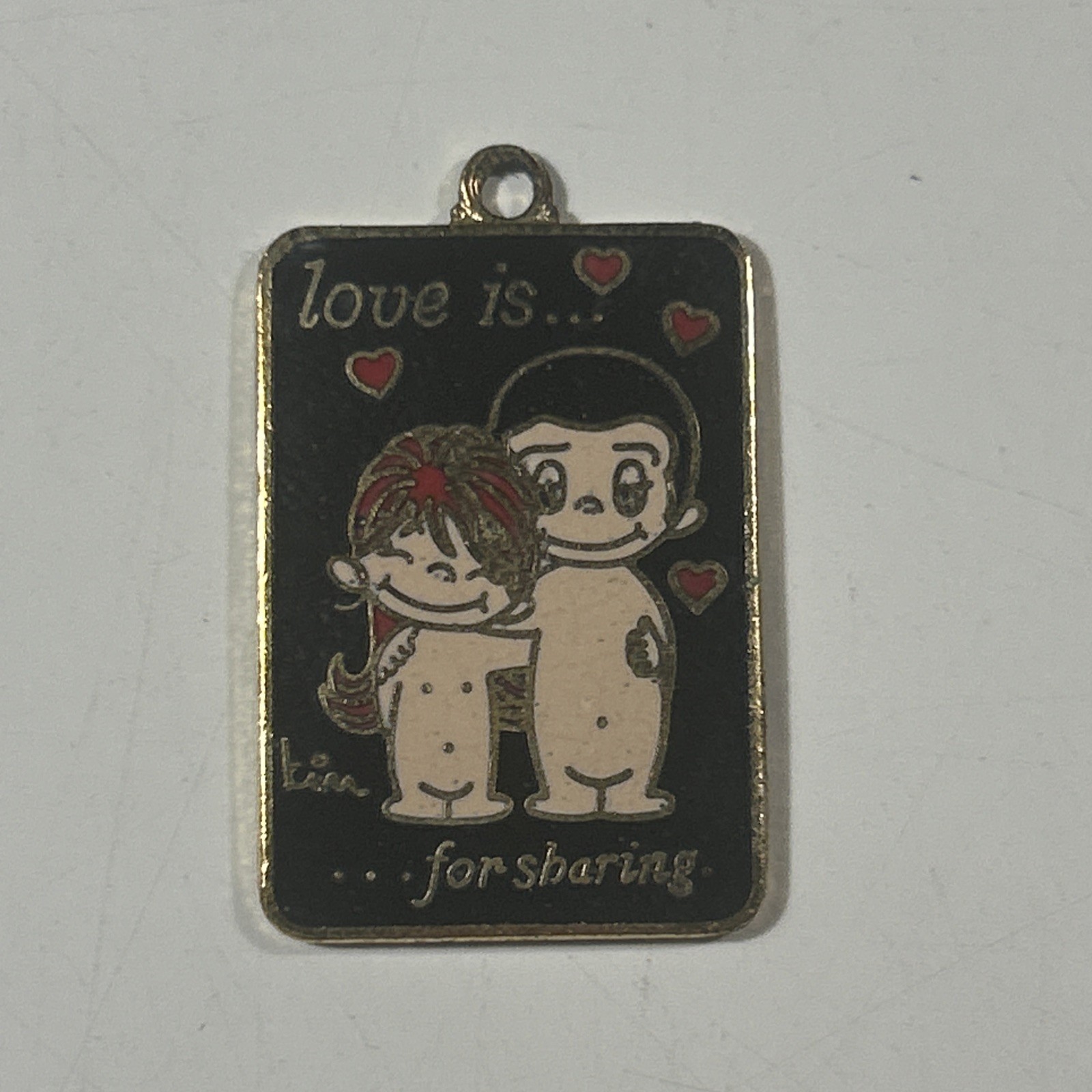 Vintage 1970s LOVE IS...for sharing pendant LA Times 1 inch