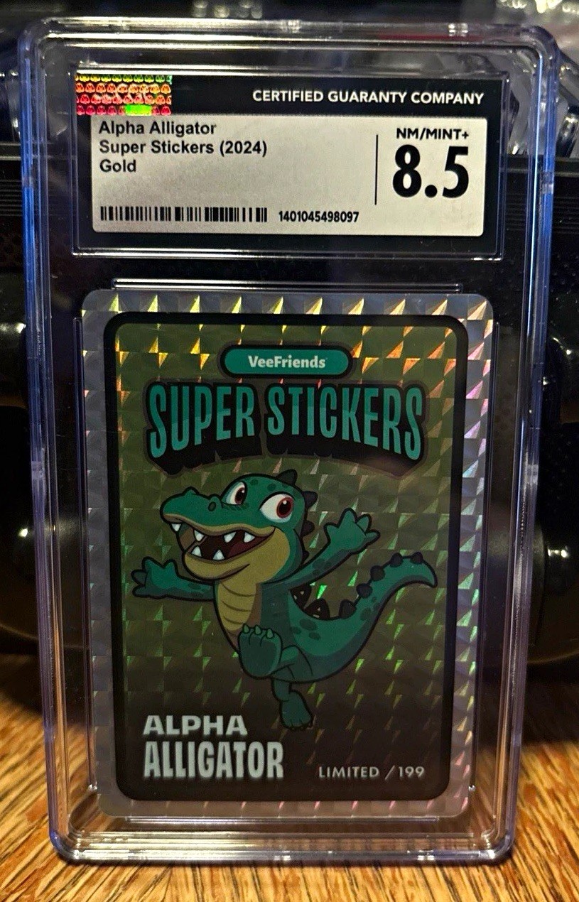 VeeFriends Alpha Alligator 2024 Super Stickers GOLD Holo CGC 8.5 NM Limited/ 199 VeeFriends Alpha Alligator 2024 Super Stickers GOLD Holo CGC 8.5 NM Limited/ 199