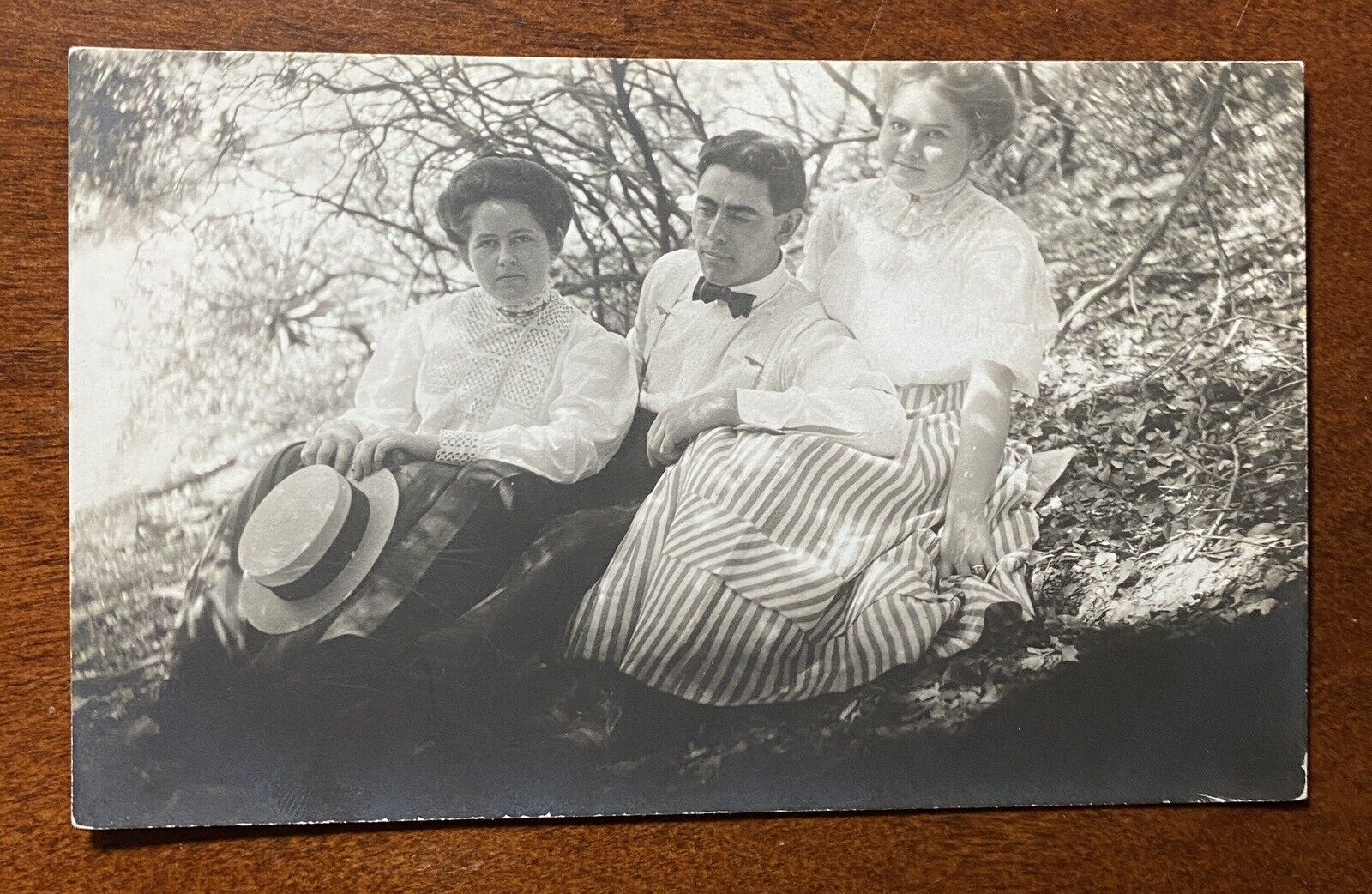 VINTAGE POSTCARD RPPC, Edwardian Era Trio relaxing outdoors, formal dress, AZO
