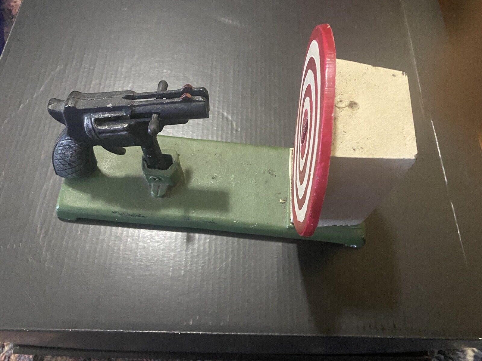 Gun into Bullseye cast iron mechanical bank