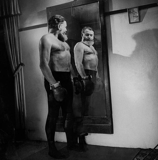 Author Ernest Hemingway admiring his mirror image bare-cheste- 1940s Old Photo