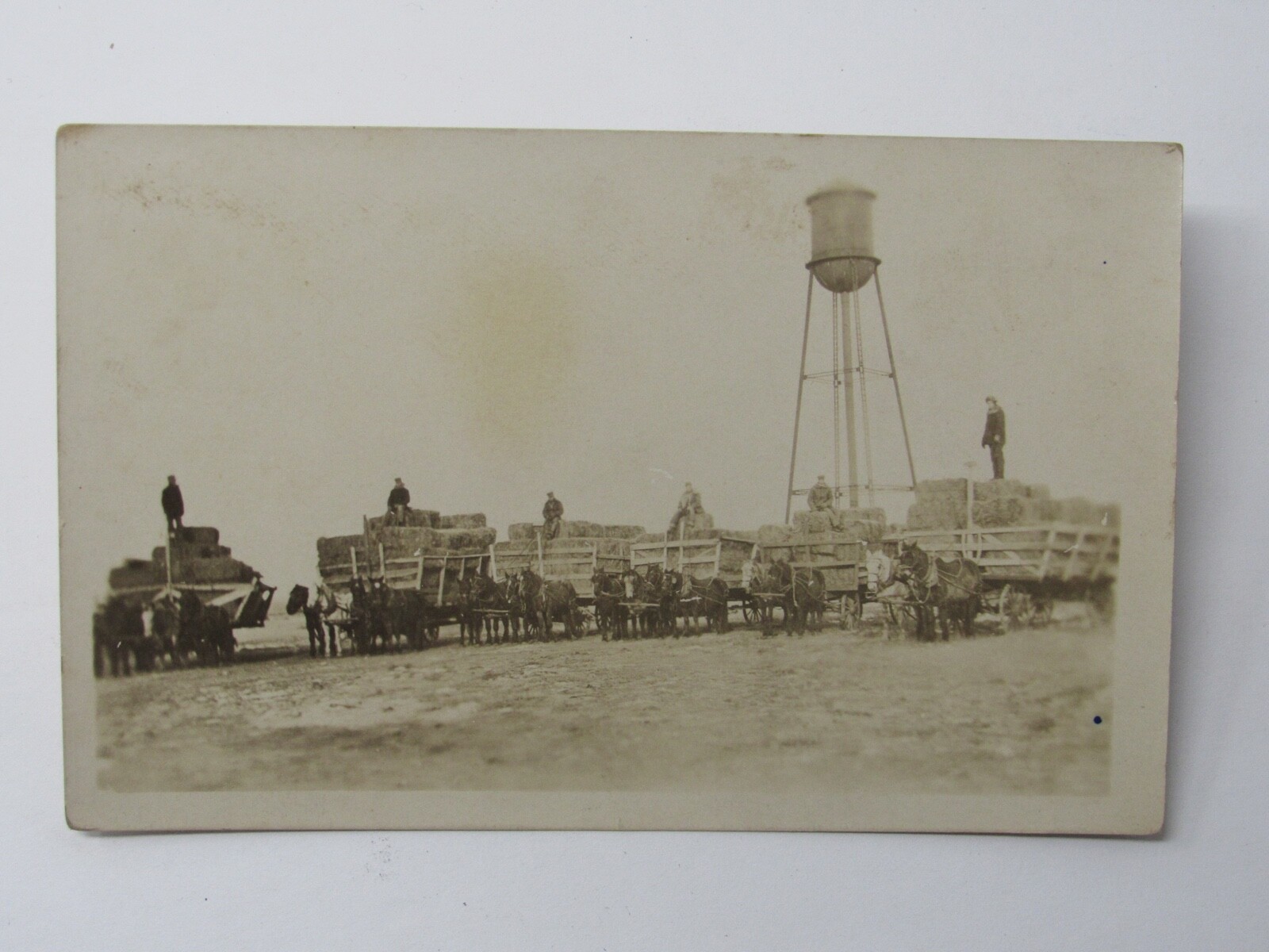 Spearfish SD Water Tower Hay Wagons Farmers Early Settlers c1915 RPPC Postcard
