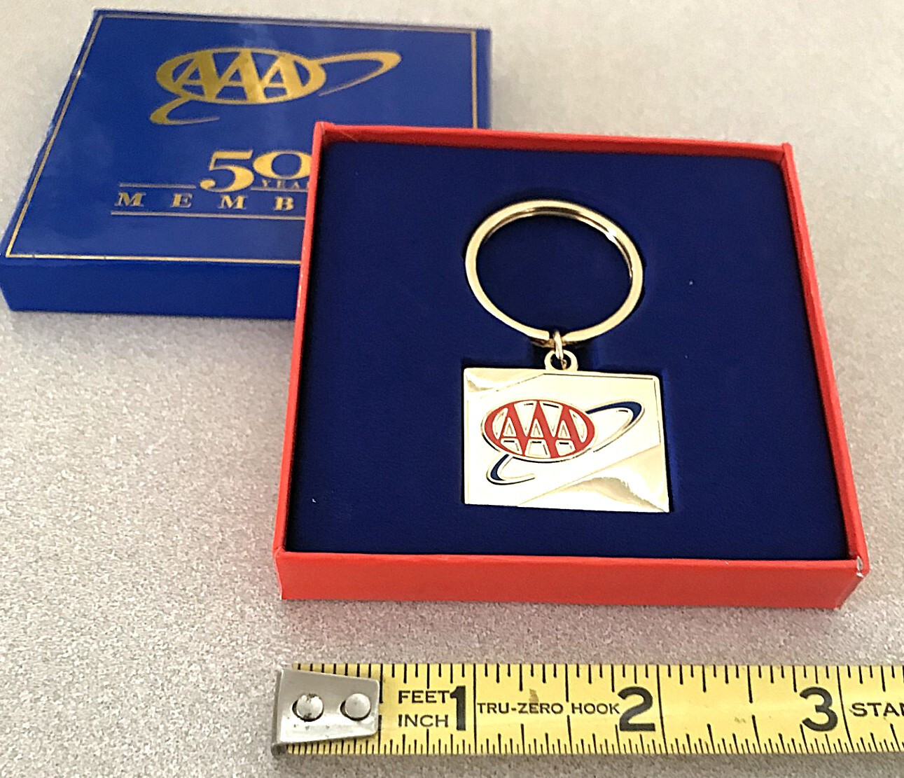 AAA 50 year member metal keychain. Gold color. New in box AAA 50 year member metal keychain. Gold color. New in box