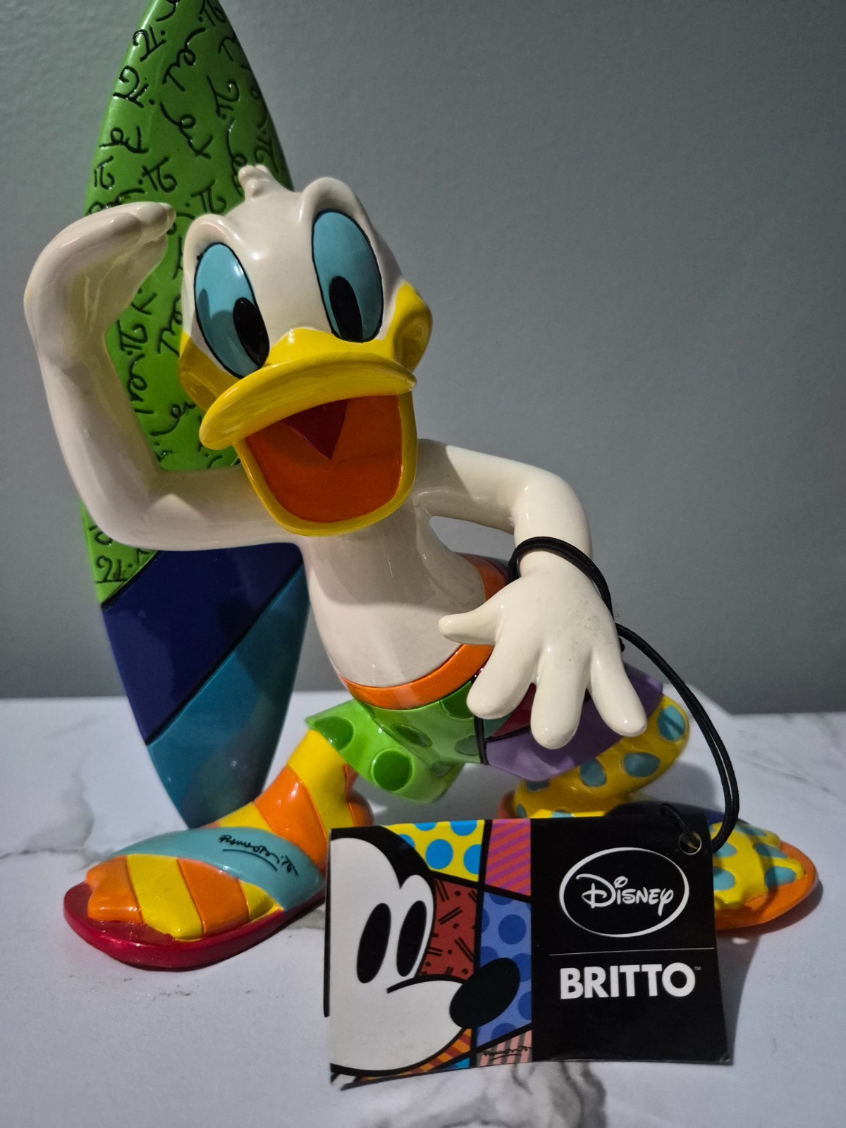 Authentic Disney Showcase by Romero Britto – Donald Duck Surfer Figurine (Large) Authentic Disney Showcase by Romero Britto – Donald Duck Surfer Figurine (Large)