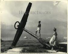 1957 Press Photo Visitors check an old anchor at Kingston Harbor in Jamaica picture