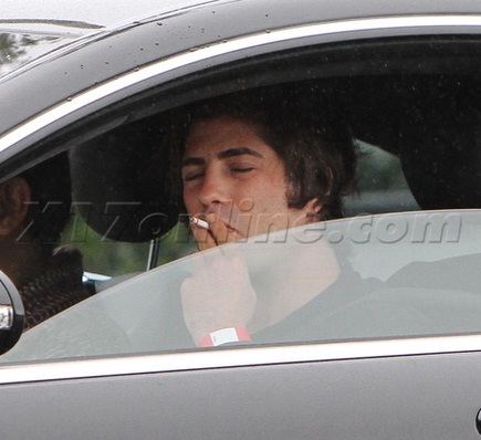 Brandon Davis puffs a cigarette in his Mercedes-Benz CL