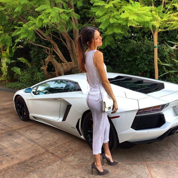Kendall Jenner posing with a Aventador