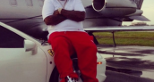 Rick Ross Sitting on a Ferrari